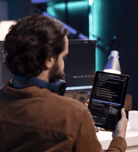 man-doing-software-quality-assurance-using-tablet-reading-source-code-2