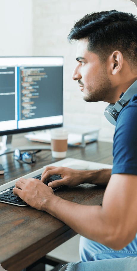 side-view-attractive-hispanic-software-developer-programming-using-computer-while-working-from-home-1