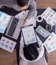 top-viewtop-view-manager-employee-doing-teamwork-business-office-looking-charts-laptop-display-1