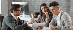young-couple-using-digital-tablet-with-their-insurance-agent-consultations-office